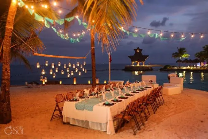 Beach dinner reception under string lights